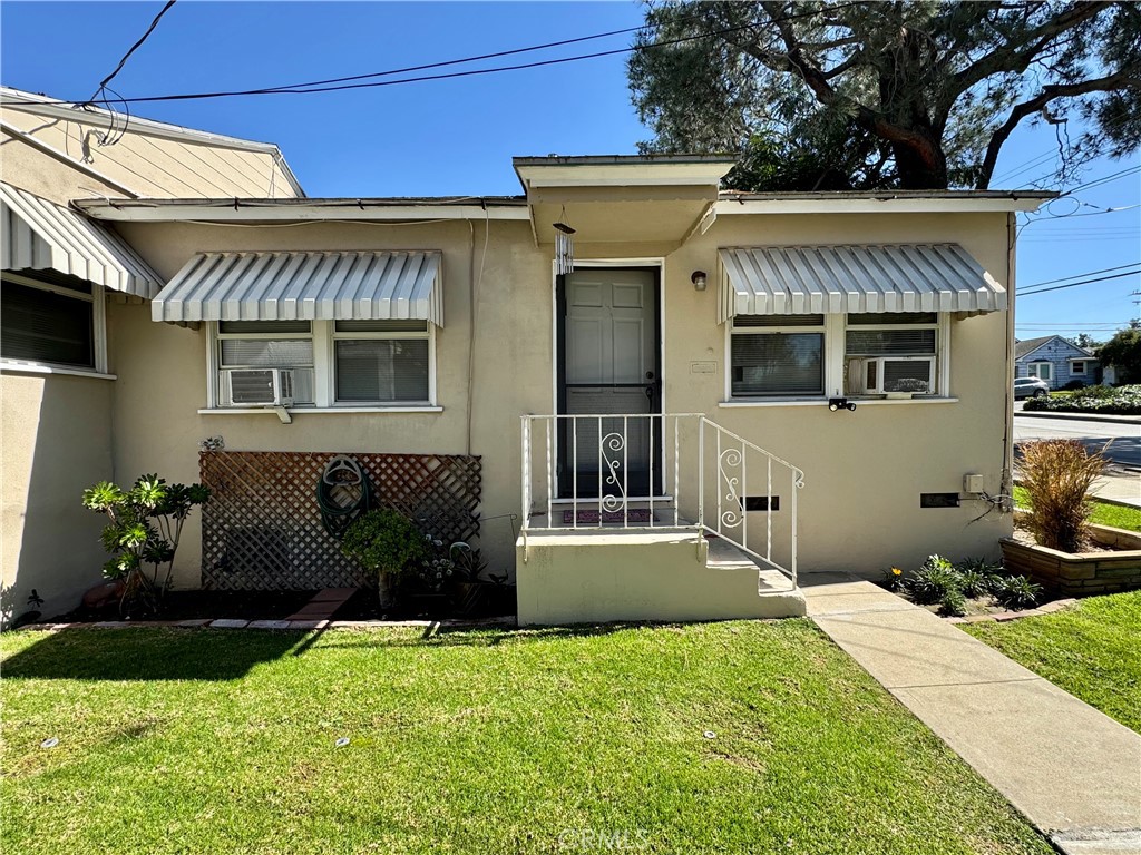 13751 Penn Street Whittier, CA 90602 - Photo 5 of 17 a front view of a house with a yard