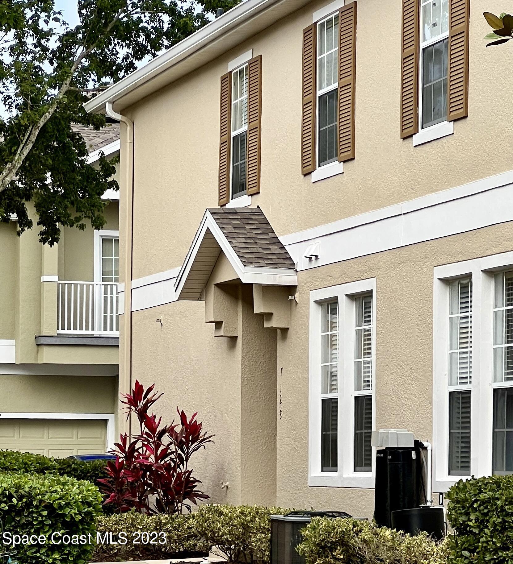 7122 Red Lantern Drive Harmony, FL 34773 - Photo 1 of 1 a front view of a house with a yard and potted plants