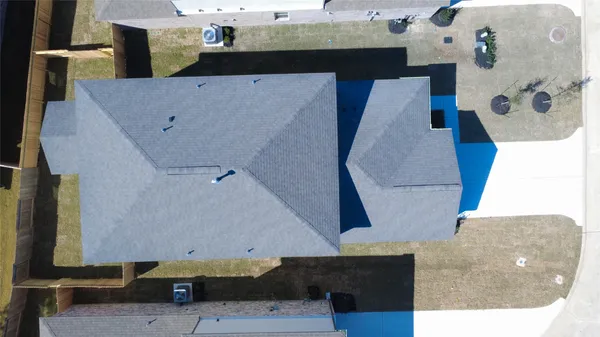 an aerial view of a house with outdoor space