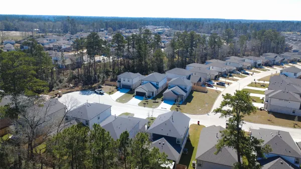an aerial view of a house with a yard