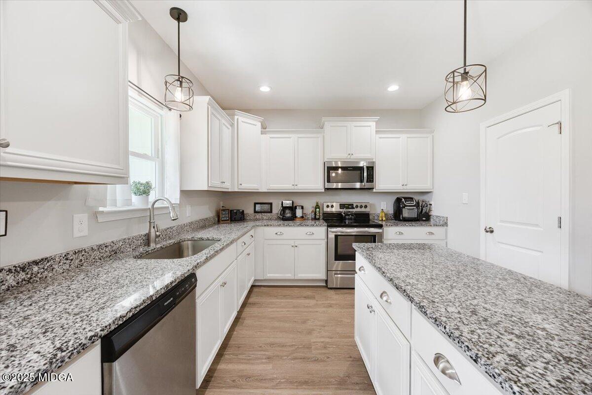 309 Davis Road Gray, GA 31032 - Photo 14 of 48 a large kitchen with granite countertop lots of counter space sink and appliances