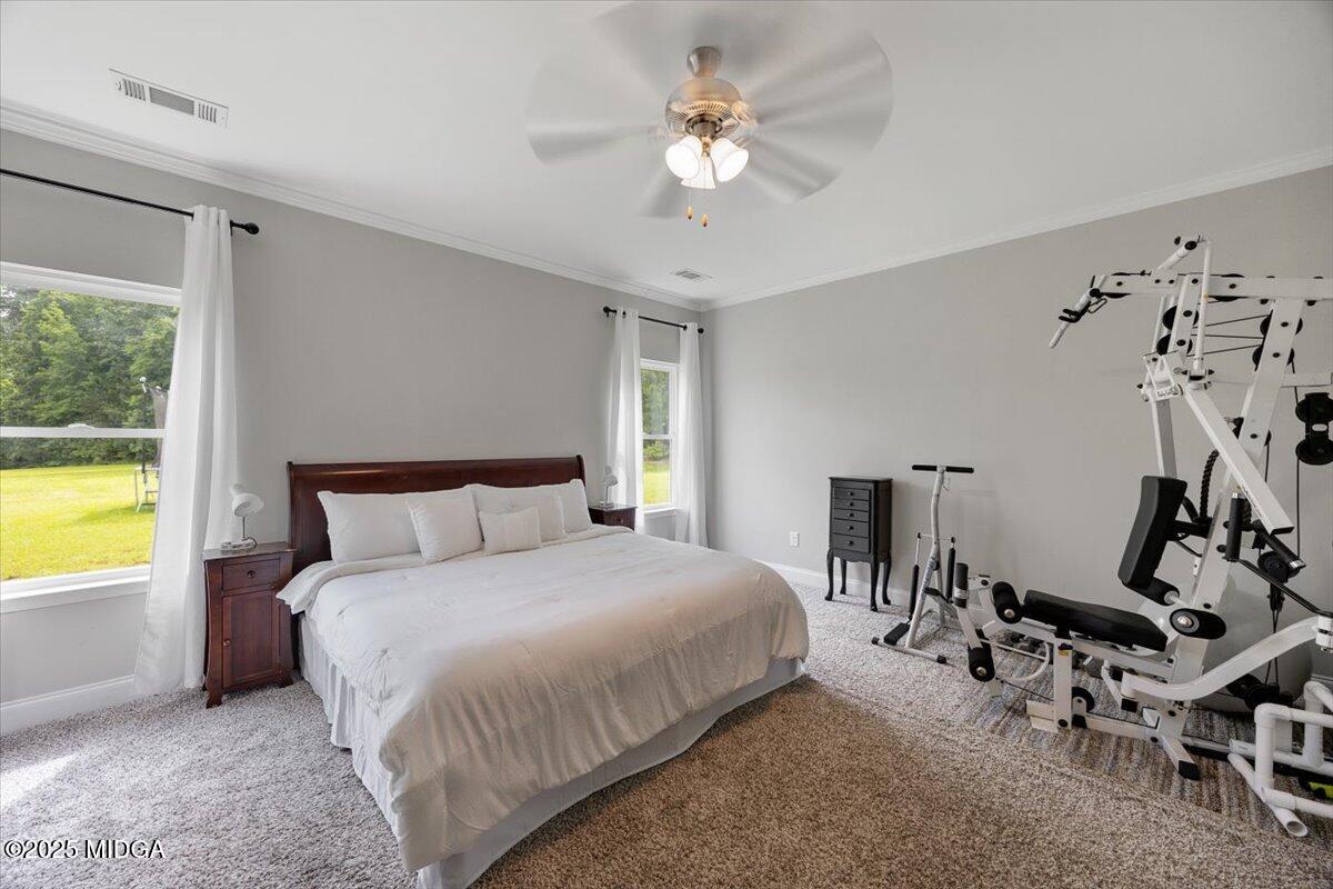 309 Davis Road Gray, GA 31032 - Photo 17 of 48 a bedroom with a bed a chandelier and a window