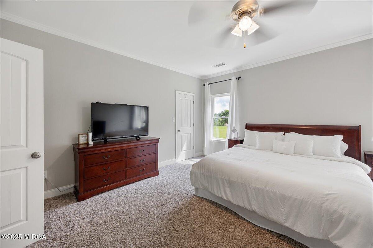 309 Davis Road Gray, GA 31032 - Photo 18 of 48 a bedroom with a bed and a flat screen tv