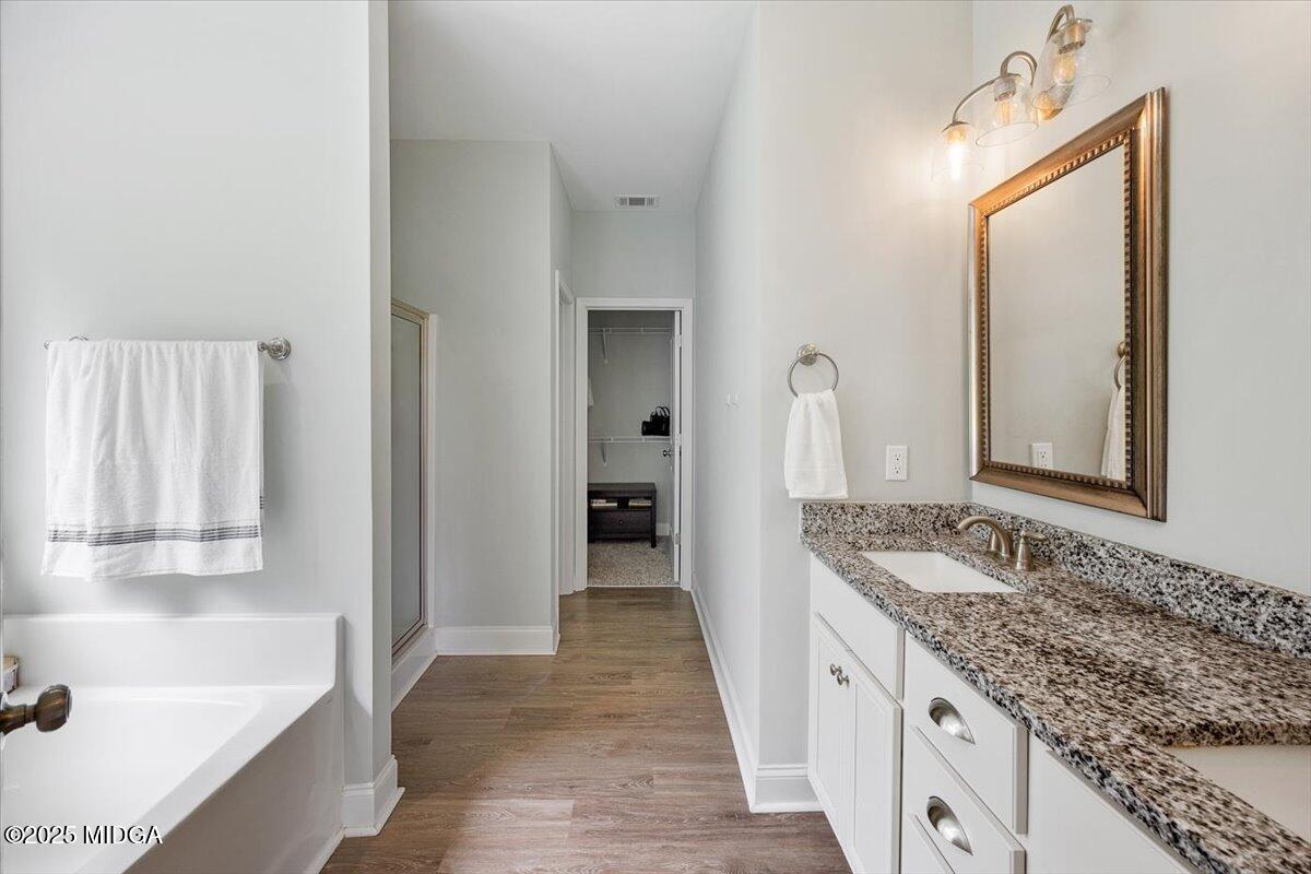 309 Davis Road Gray, GA 31032 - Photo 19 of 48 a en suite bathroom with a granite countertop sink and a mirror