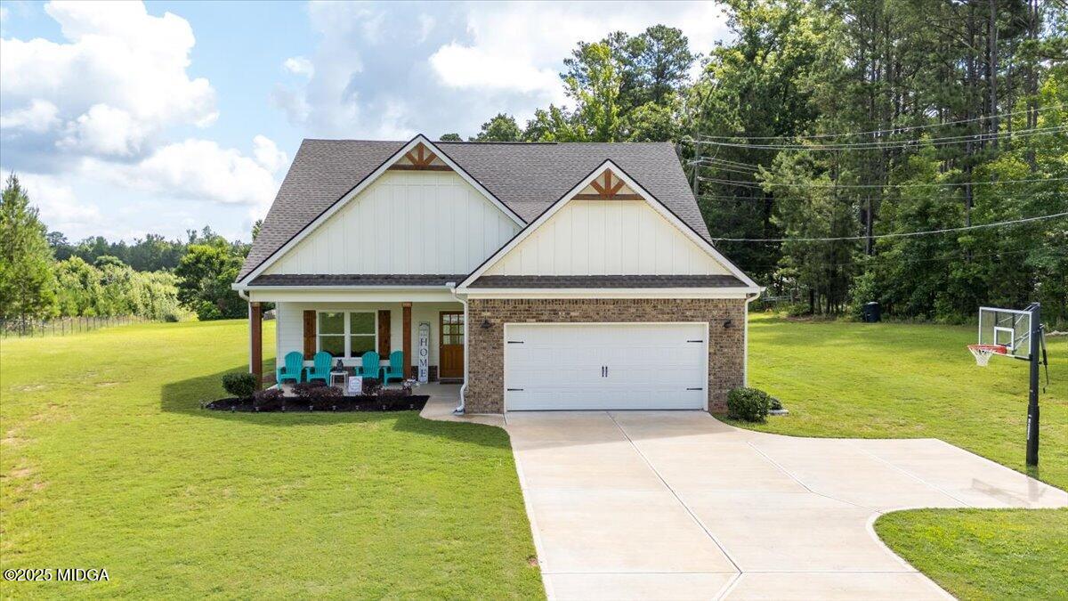 309 Davis Road Gray, GA 31032 - Photo 2 of 48 a front view of a house with a garden