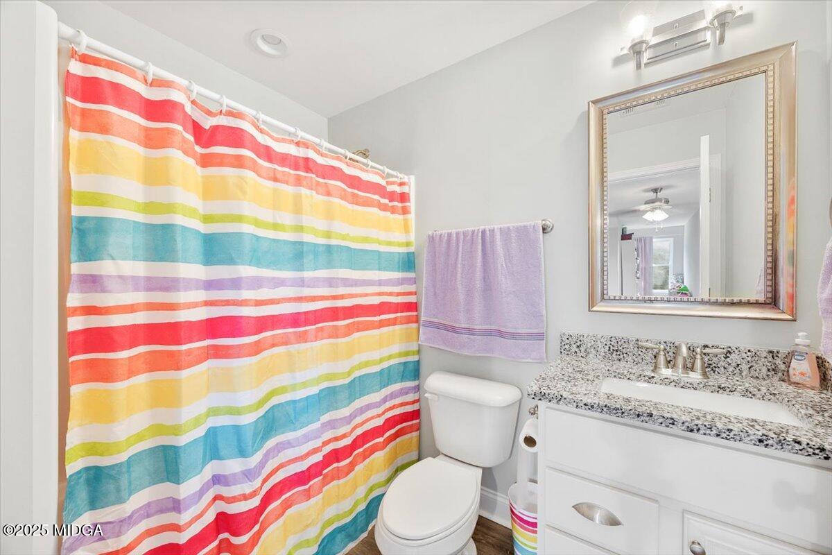 309 Davis Road Gray, GA 31032 - Photo 22 of 48 a bathroom with a sink toilet and shower curtain