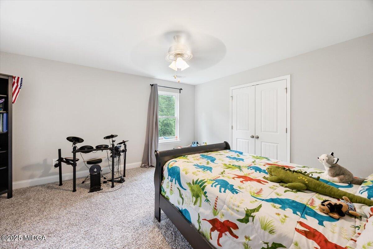 309 Davis Road Gray, GA 31032 - Photo 23 of 48 a bedroom with a bed and a chandelier