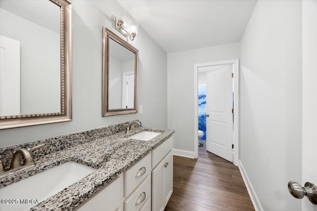 309 Davis Road Gray, GA 31032 - Photo 26 of 48 a bathroom with a granite countertop sink and a mirror