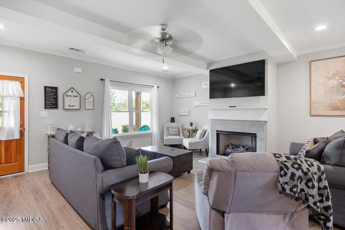 309 Davis Road Gray, GA 31032 - Photo 8 of 48 a living room with furniture a flat screen tv and a fireplace