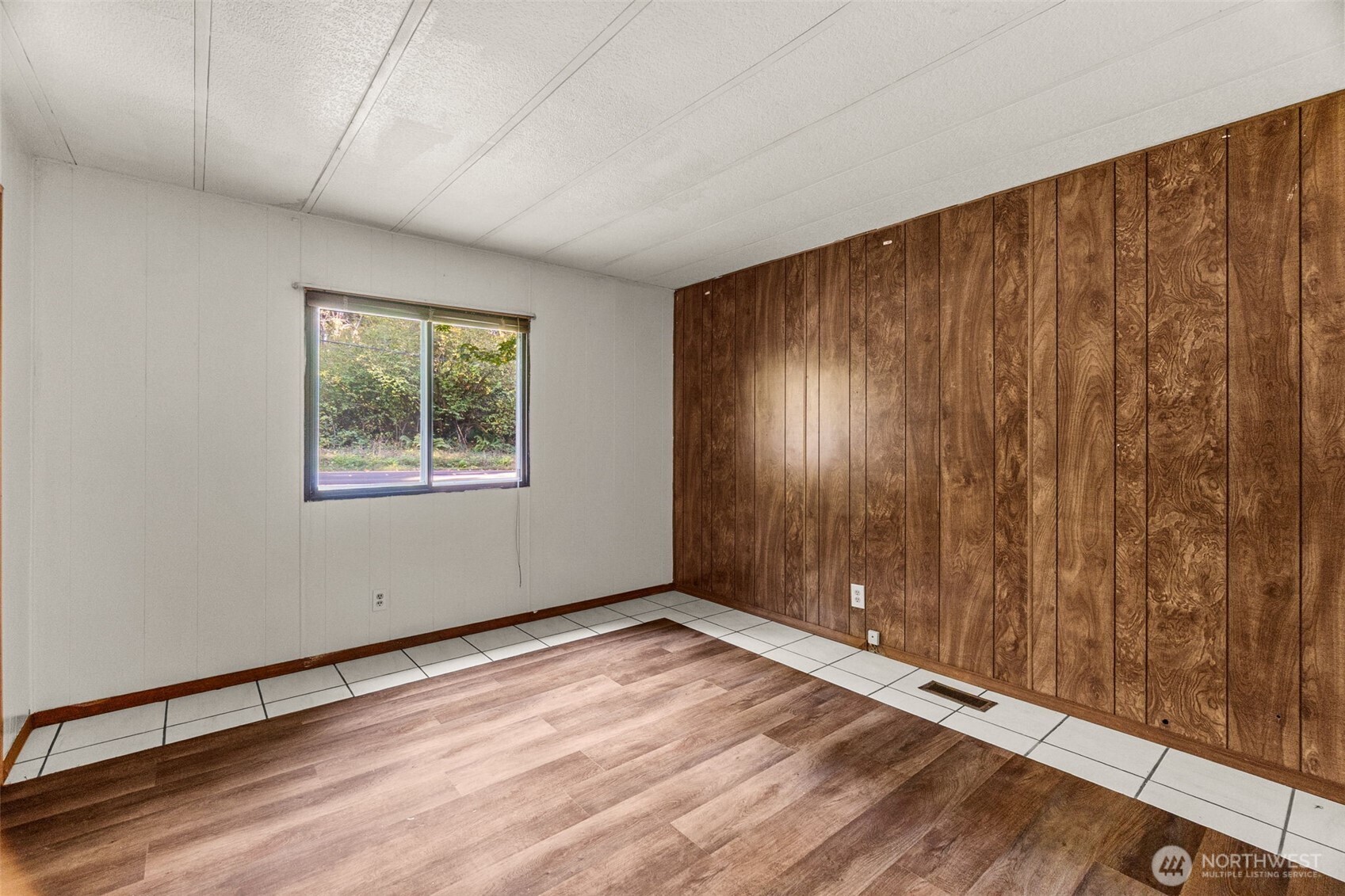4312 Meridian Road Northeast Lacey, WA 98516 - Photo 16 of 21 a view of an empty room with window and wooden floor