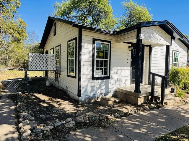 a front view of a house with sitting area