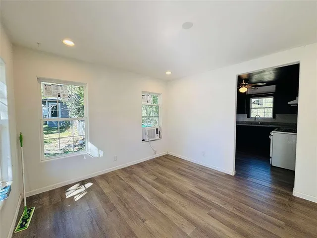wooden floor in an empty room with a window