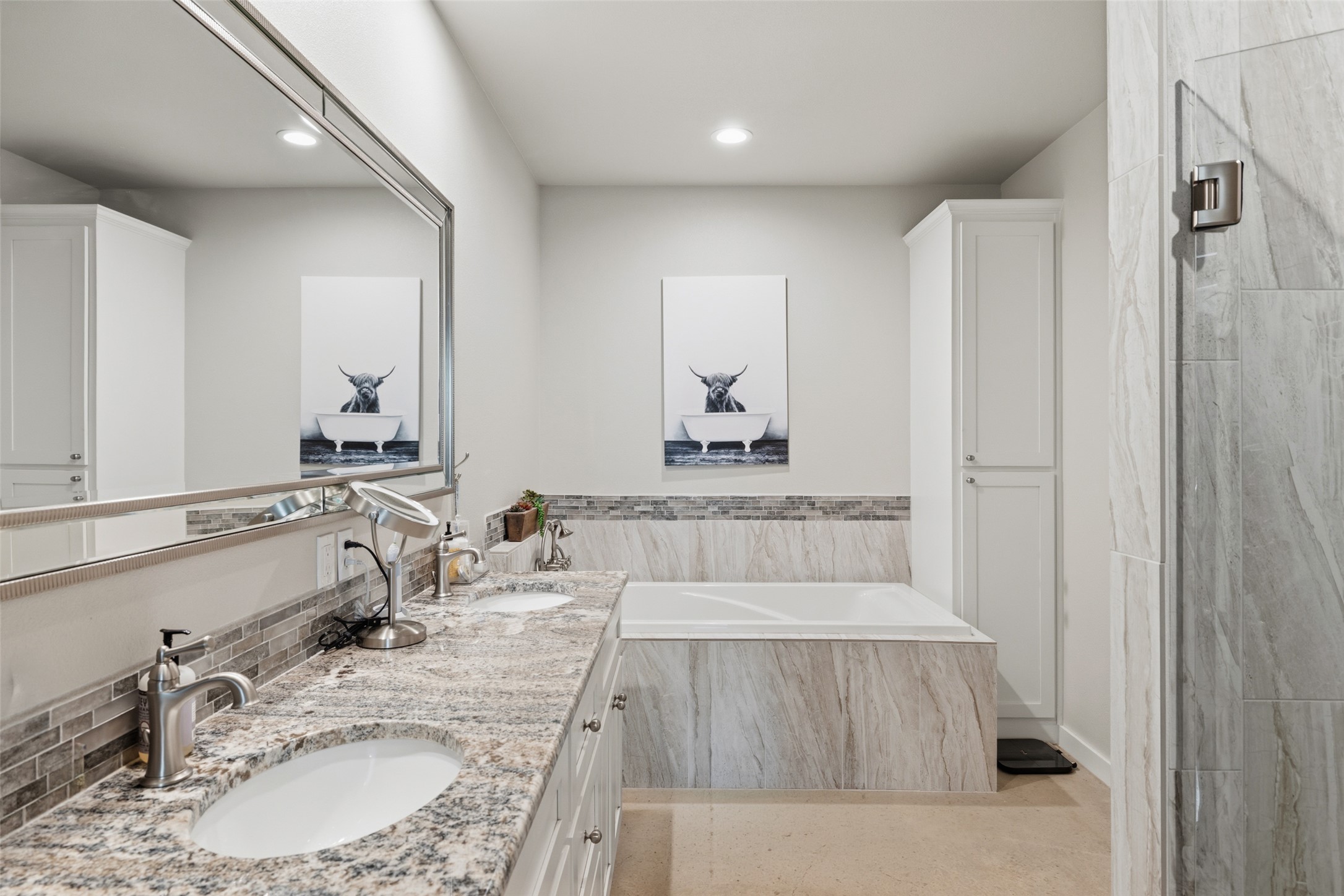 764 Stubbs Road Johnson City, TX 78636 - Photo 24 of 29 Dual vanity with ample counter space and a sleek, built-in bathtub create a tranquil bathing retreat.
