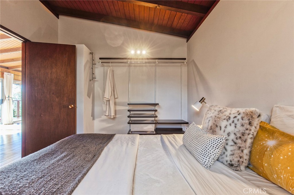 3105 Knob Street Nice, CA 95464 - Photo 24 of 36 a bedroom with a large bed and a chandelier