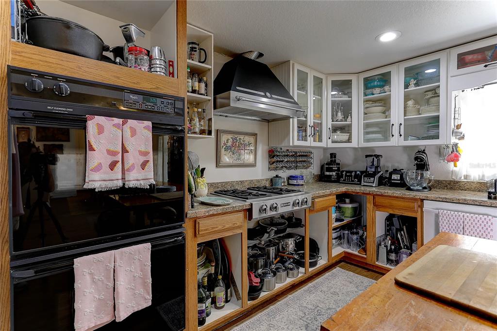 20490 Pinewood Dairy Road Brooksville, FL 34601 - Photo 24 of 52 a kitchen with stainless steel appliances granite countertop a stove and a sink