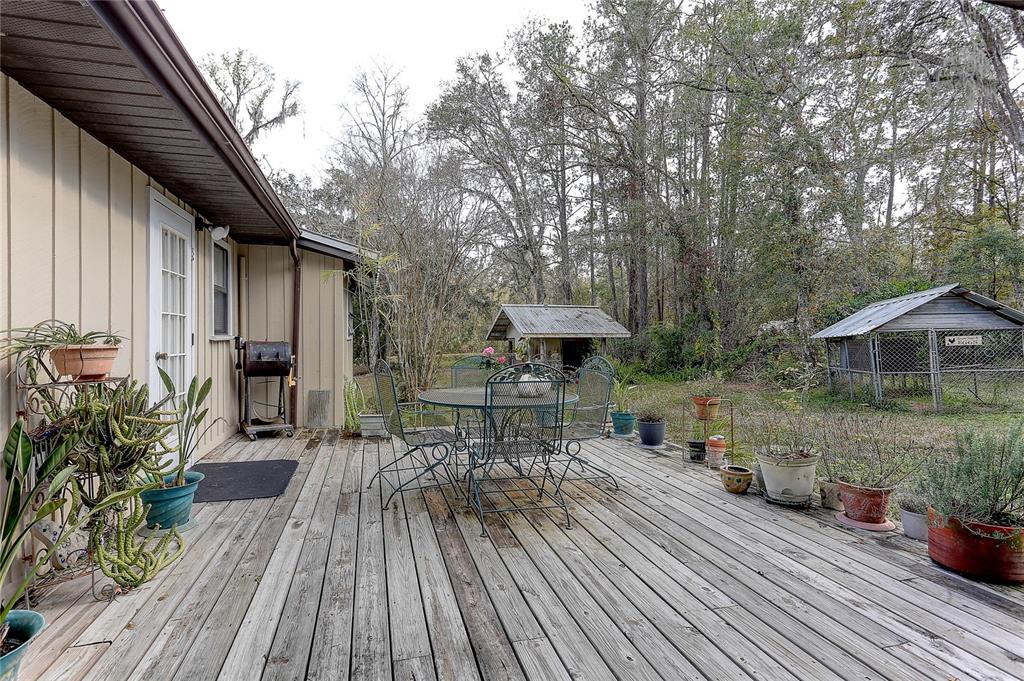 20490 Pinewood Dairy Road Brooksville, FL 34601 - Photo 28 of 52 a view of a house with backyard and sitting area
