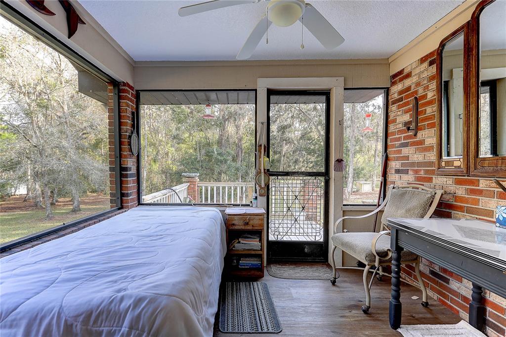 20490 Pinewood Dairy Road Brooksville, FL 34601 - Photo 36 of 52 a bedroom with a bed and a large window