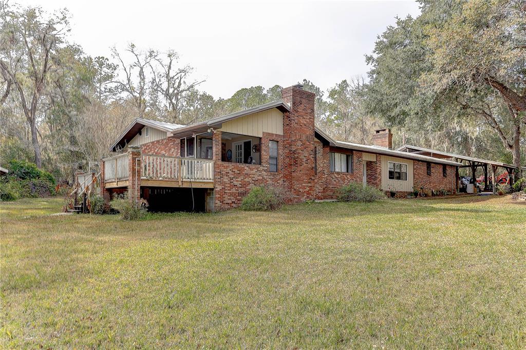 20490 Pinewood Dairy Road Brooksville, FL 34601 - Photo 6 of 52 a front view of house with yard and trees in the background