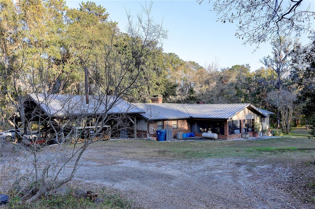20490 Pinewood Dairy Road Brooksville, FL 34601 - Photo 8 of 52 a front view of a house with a yard