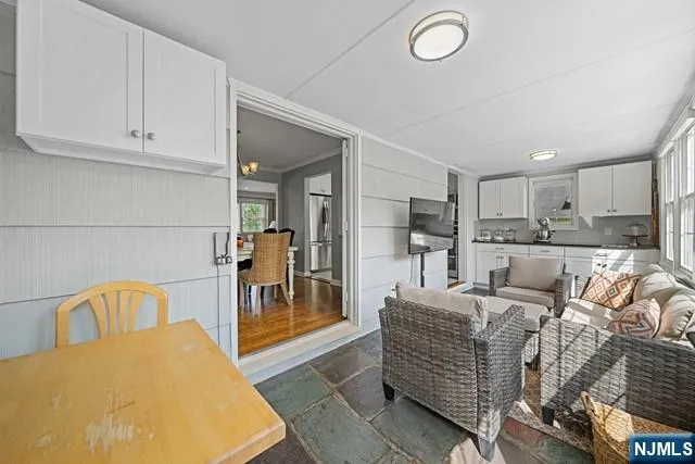 a living room with furniture and a dining table