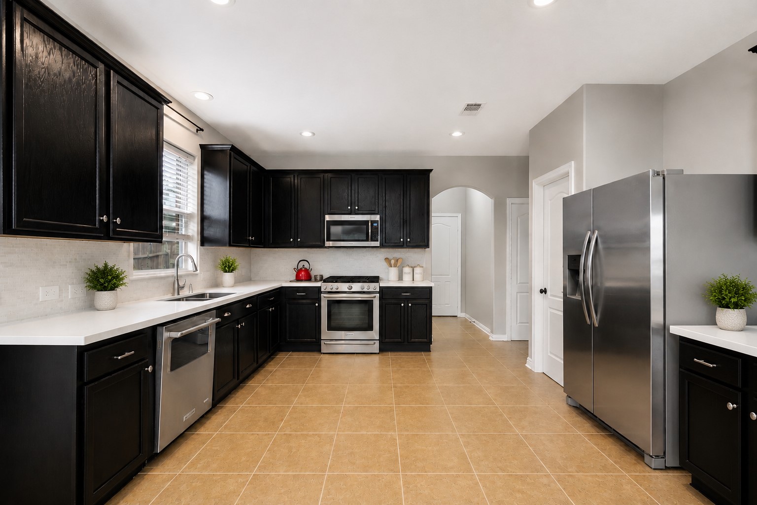 9438 Emerald Lakes Drive Rosharon, TX 77583 - Photo 7 of 36 a large kitchen with stainless steel appliances granite countertop a stove a sink dishwasher a refrigerator and a microwave oven