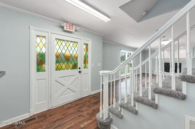 a view of entryway and hall with wooden floor