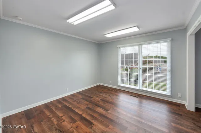 wooden floor in an empty room with a window
