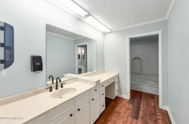 a spacious bathroom with a double vanity sink and mirror