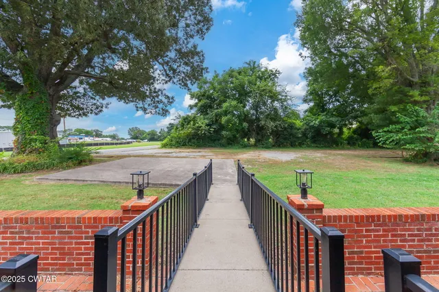 a view of a brick house with a yard