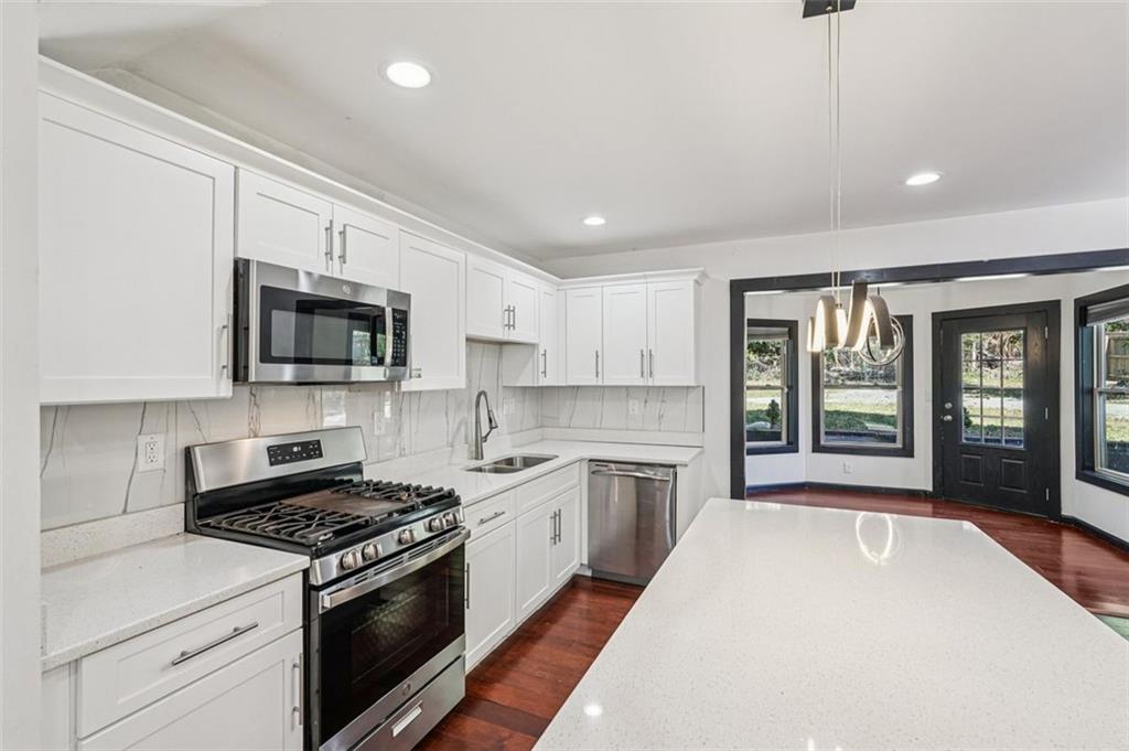 1689 Derry Avenue Southwest Atlanta, GA 30310 - Photo 11 of 51 a large kitchen with stainless steel appliances granite countertop a stove a sink and a microwave