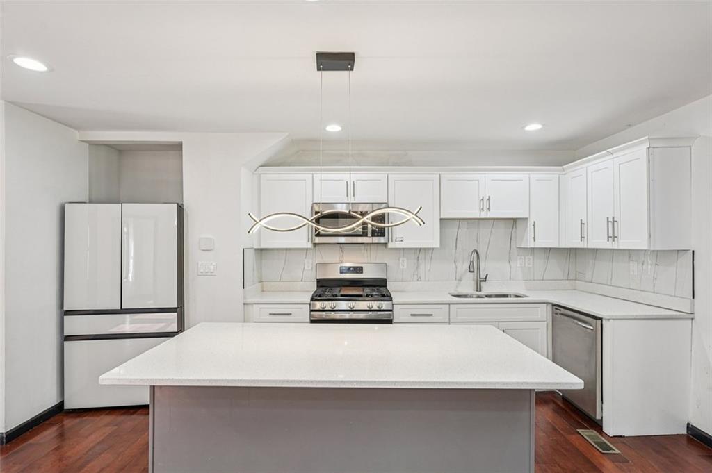 1689 Derry Avenue Southwest Atlanta, GA 30310 - Photo 12 of 51 a kitchen with kitchen island white cabinets and stainless steel appliances