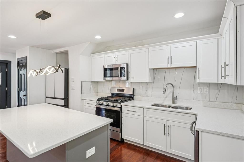 1689 Derry Avenue Southwest Atlanta, GA 30310 - Photo 13 of 51 a kitchen with a sink a stove and refrigerator