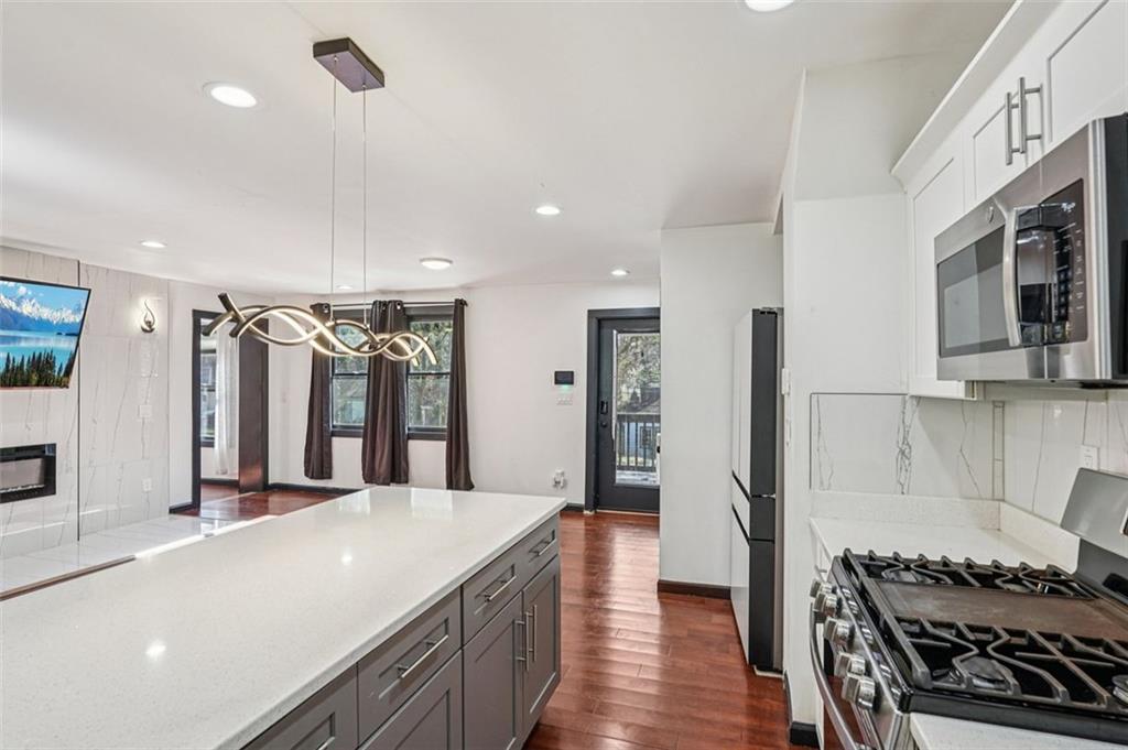 1689 Derry Avenue Southwest Atlanta, GA 30310 - Photo 14 of 51 a large kitchen with stainless steel appliances a large counter top a stove and a refrigerator