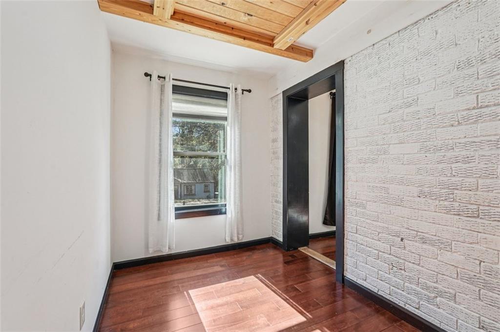 1689 Derry Avenue Southwest Atlanta, GA 30310 - Photo 18 of 51 a view of an empty room with wooden floor and a window