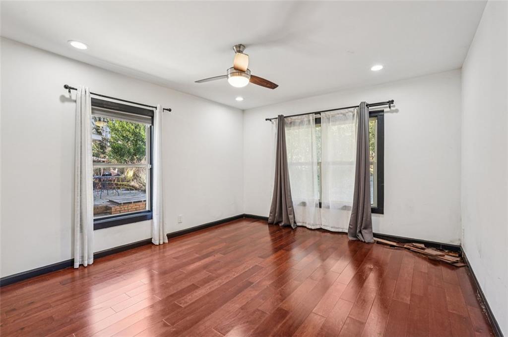1689 Derry Avenue Southwest Atlanta, GA 30310 - Photo 22 of 51 an empty room with wooden floor cabinet and windows
