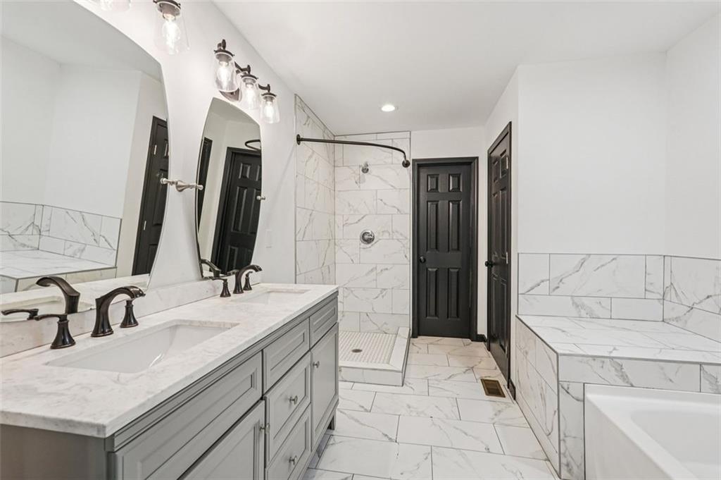 1689 Derry Avenue Southwest Atlanta, GA 30310 - Photo 25 of 51 a spacious bathroom with a double vanity sink mirror and bathtub