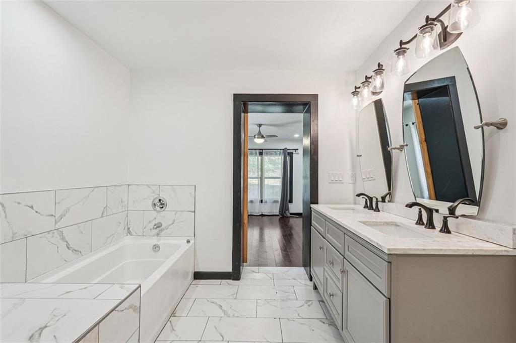 1689 Derry Avenue Southwest Atlanta, GA 30310 - Photo 27 of 51 a bathroom with a bathtub sink and mirror