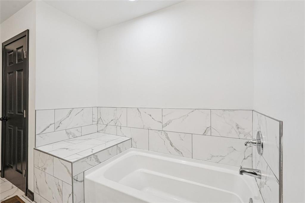 1689 Derry Avenue Southwest Atlanta, GA 30310 - Photo 28 of 51 a bathroom with a bathtub and vanity