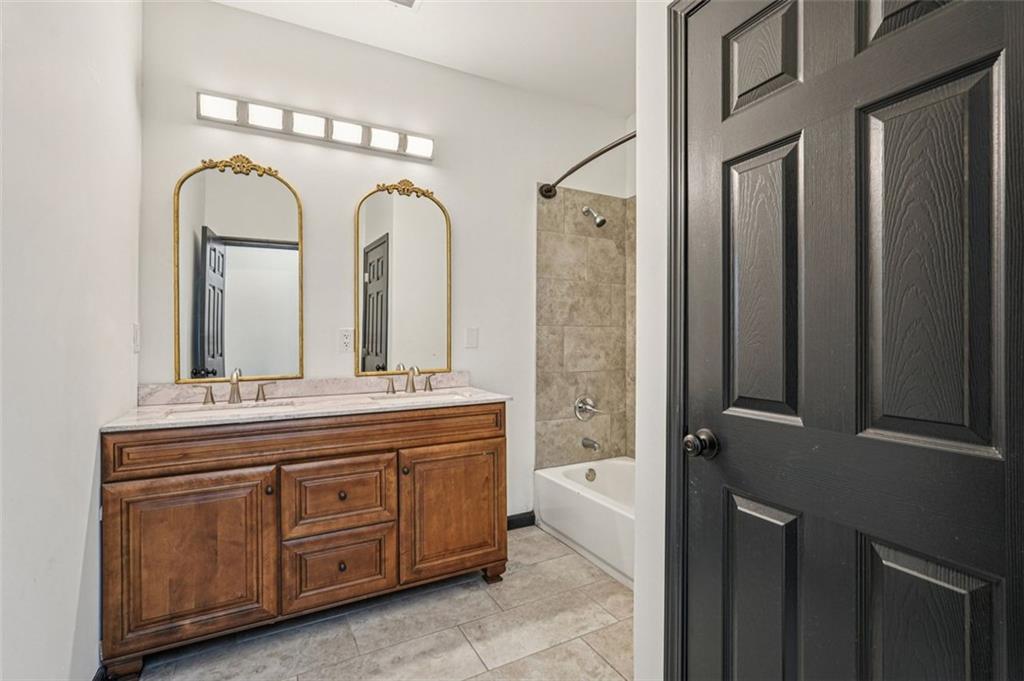 1689 Derry Avenue Southwest Atlanta, GA 30310 - Photo 35 of 51 a bathroom with a granite countertop toilet a sink and a mirror