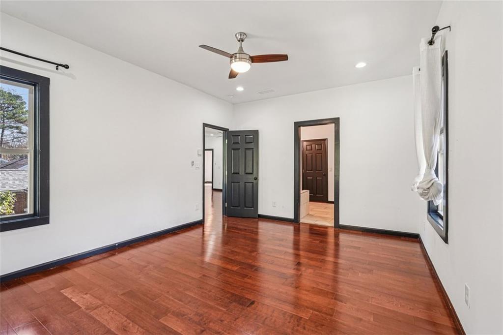 1689 Derry Avenue Southwest Atlanta, GA 30310 - Photo 40 of 51 a view of an empty room with wooden floor and a ceiling fan