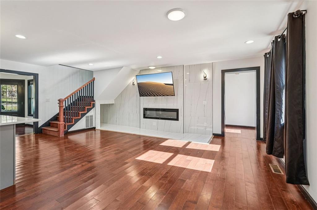 1689 Derry Avenue Southwest Atlanta, GA 30310 - Photo 4 of 51 a view of an empty room with wooden floor and a window