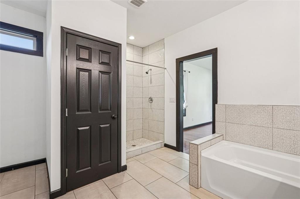 1689 Derry Avenue Southwest Atlanta, GA 30310 - Photo 42 of 51 a bathroom with a bathtub and a shower