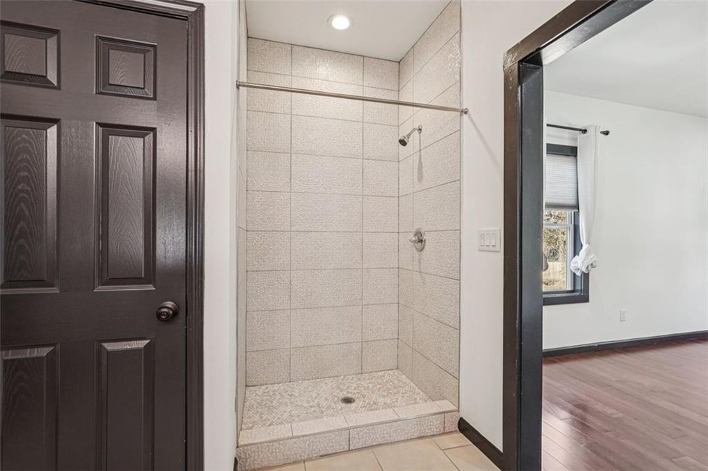 1689 Derry Avenue Southwest Atlanta, GA 30310 - Photo 43 of 51 a bathroom with a glass shower door