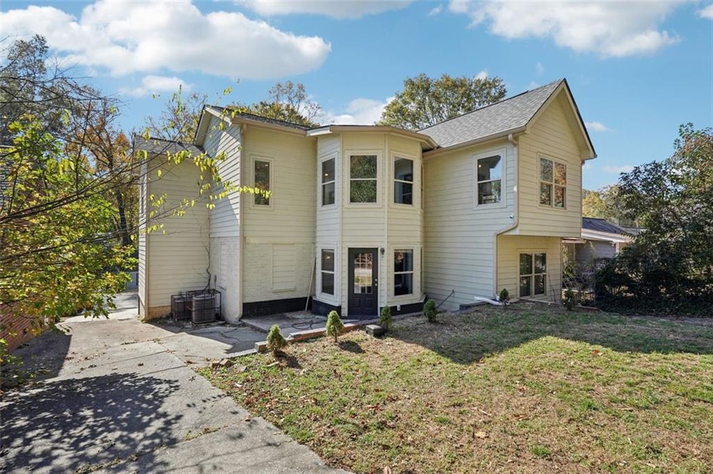 1689 Derry Avenue Southwest Atlanta, GA 30310 - Photo 45 of 51 a view of a white house with a yard and large tree