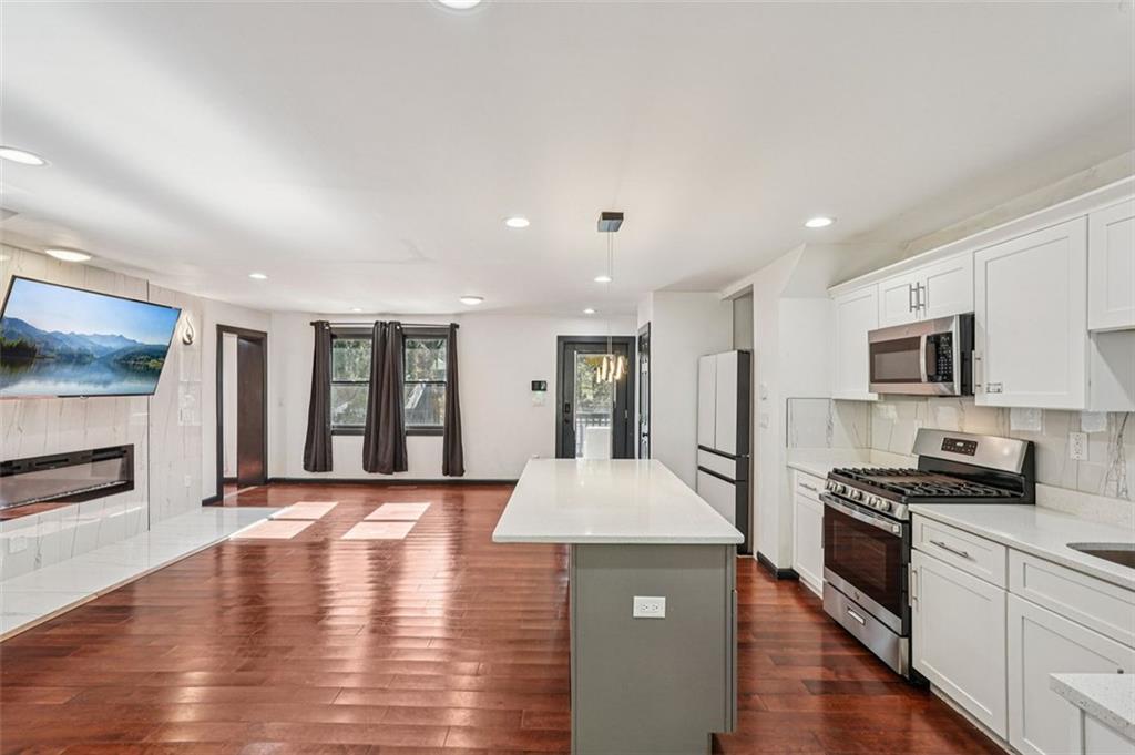 1689 Derry Avenue Southwest Atlanta, GA 30310 - Photo 7 of 51 a large kitchen with stainless steel appliances granite countertop a large center island a stove and a refrigerator