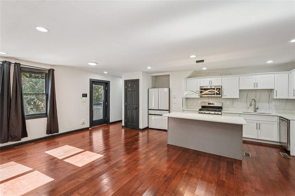 1689 Derry Avenue Southwest Atlanta, GA 30310 - Photo 8 of 51 a large kitchen with stainless steel appliances granite countertop a stove and a refrigerator