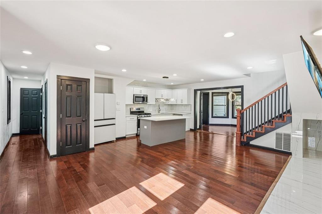 1689 Derry Avenue Southwest Atlanta, GA 30310 - Photo 9 of 51 a living room with furniture and a kitchen view with wooden floor