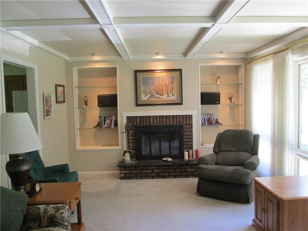 163 Thompson Road Beaver Falls, PA 15010 - Photo 8 of 24 Ginormous Living Room (12x22) has a beautiful brick wood burning fire place, beamed ceiling, recessed lighting with dimmers, built-ins and huge windows that let in tons of light.