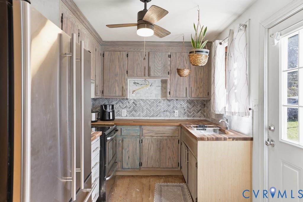 3200 Manorcrest Road Richmond, VA 23234 - Photo 25 of 34 a kitchen with a refrigerator a sink and cabinets