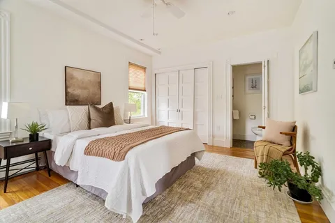a bedroom with bed and window